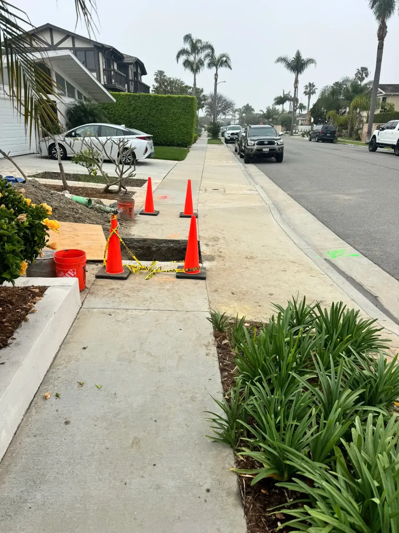 Curbside sewer lateral work with safety cones in Orange County