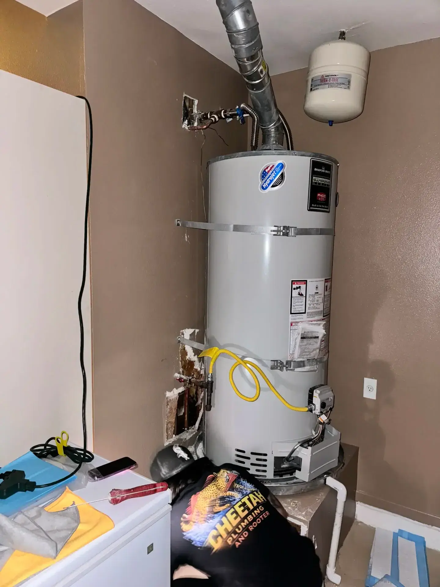 Cheetah technician installing a Bradford White water heater